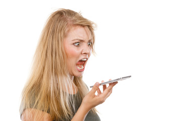 Angry young woman talking on phone