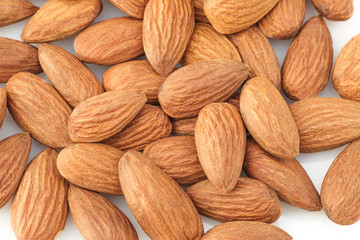 peeled almond seed on white background