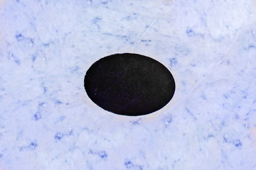 Blue background of marble and black oval in the middle for text