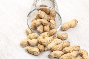 crude peanuts on the wooden background