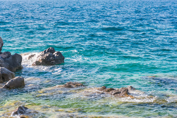 Waves break about the coastal stones in the Adriatic Sea. Montenegro, Boka-Kotor Bay.