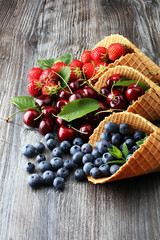 Berries in waffle cones - strawberry, blueberry and black cherry