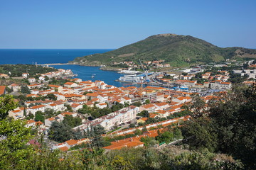Fototapeta na wymiar The coastal town of Port Vendres with its harbor and the fort Bear in background, seen from the heights, Mediterranean sea, Roussillon, Pyrenees Orientales, Cote Vermeille, south of France