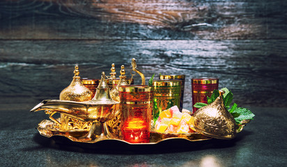 Fototapeta na wymiar Golden decoration oriental lantern Tea glasses mint leaves vintage