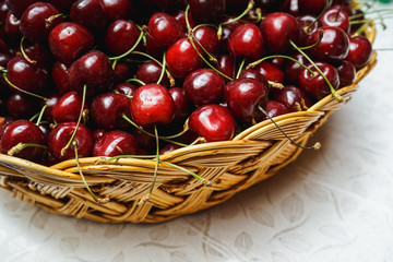a lot of fresh cherries in a basket