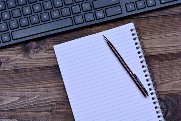 Notepad with keyboard computer on table