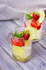 Strawberry mojito. Detox fruit and berry infused flavored water in jars. Refreshing summer homemade cocktail