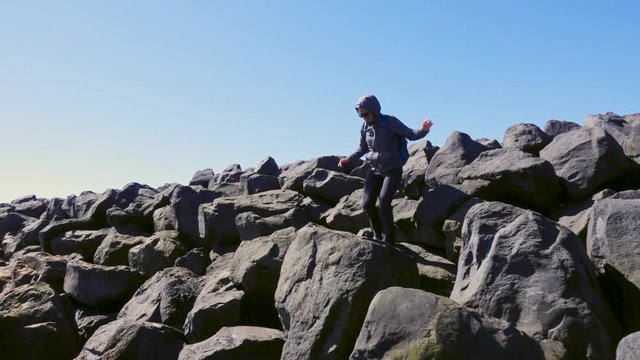 Woman exploring beautiful Reynisfjara beach near Vik, Icealnd