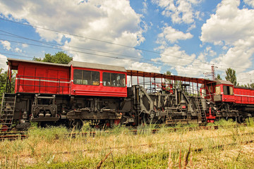 Railway track service car fixing and repairing the railroad in rural area.