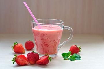 A glass of smoothies with strawberries and mint