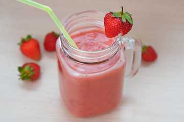Strawberry smoothies in a glass jar, berries