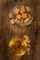 Caramel Sirup (selective focus) on vintage wooden background