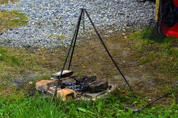 Cooking on a fire in the open air, fire, stand on three supports under the pot