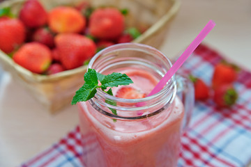Strawberry smoothies in a glass jar, berries, and mint  Healthy food concept