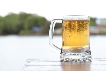 Glass beer for drink near the riverside restaurant