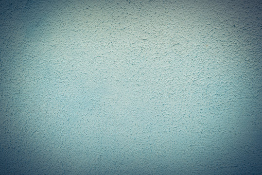 Close-up, full frame view a well-done light blue/cyan wall texture background. Painted cement wall backdrop. Design element. Vintage tone.