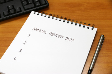 Annual report 2017 on paper milestones aligned on the desk .are representative of success in the past and goal for the future in this 2018