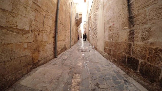 Narrow Ancient Street Paved With Stones Some Men and Woman go Out House Urfa