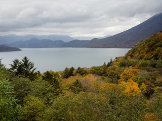 Fototapeta na wymiar Fall colors in Nikko national park, Japan - view of Mount Nantai and lake Chuzenji