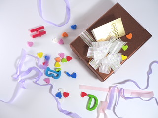 Gift boxes and ribbons and letters on white background