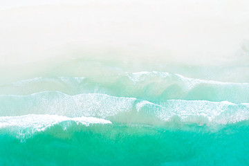 Obraz na płótnie Canvas Top view of waves on white sand beach