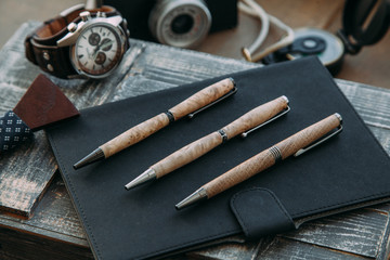 Exclusive pen on wood background