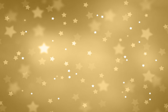 Beautiful blurry star shape bokeh background. Christmas and New Year Holidays copy space greeting card. Lovely gold colored Xmas illustration.