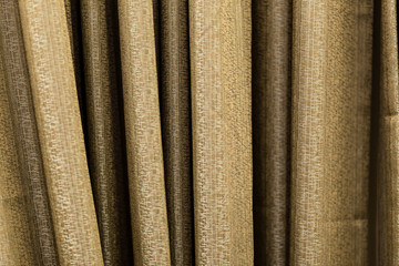 Curtain. Shooting at close range. The texture of the fabric is visible. Color gold.