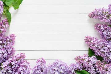 Lilac flowers floral background. Lilac flowers frame composition with copy space on vintage white wooden background. Top view flat lay