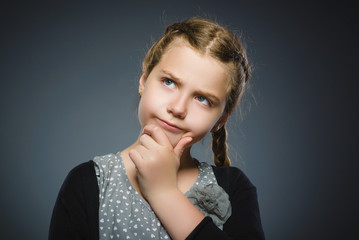 Closeup Thoughtful girl with Hand at head isolated on Gray