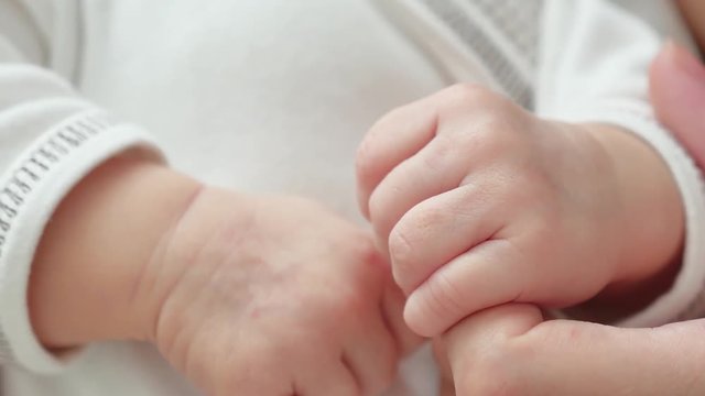 child is holding his mother hand