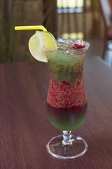 Alcohol bar, cocktail glass on the bar counter, cocktail glass in a bar. Drinking cocktails. Fresh drink cocktail on a color background.