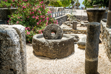 Ancient millstone for olive oil press in Capernaum, Israel - obrazy, fototapety, plakaty