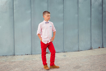 fashion boy red pants and pink shirt posing outdoor