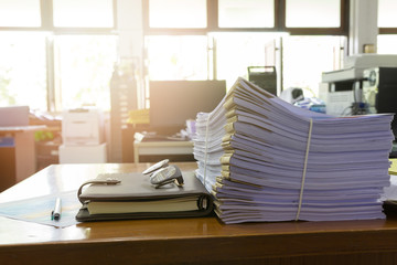 Fototapeta na wymiar Pile of unfinished documents on office desk, Stack of business paper