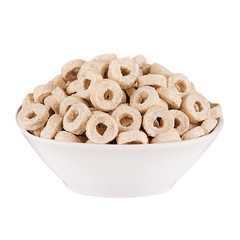 Beige rings corn flakes in white bowl isolated on white background. Cereals.