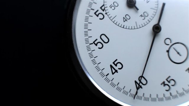 Video showing close-up Stopwatch. Clock on a dark background