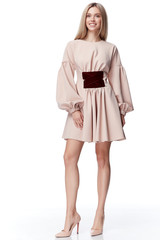 Sexy pretty fashion model blond hair woman wear style for party office clothes organic natural beige dress white background makeup lady perfect body shape shop magazine cover catalog collection.