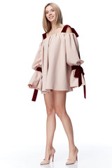 Sexy pretty fashion model blond hair woman wear style for party office clothes organic natural beige dress white background makeup lady perfect body shape shop magazine cover catalog collection.