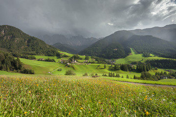 Fototapeta na wymiar Small Italian mountain town in the Dolomites ( St. Magdalena in Val di Funes )