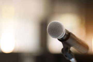 Close up of classic microphone on note stand in bokeh background