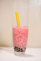 Boba / Bubble tea. Homemade Strawberry Milk Tea with Pearls on wooden table.