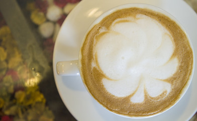 Cup of coffee latte in coffee shop