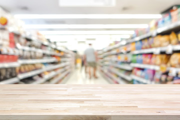 Wood table top on blur supermarket background