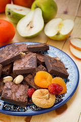Pile of Delicious Chocolate Brownies. Horizontal, rustic style. Wooden background. Close-up. Top view
