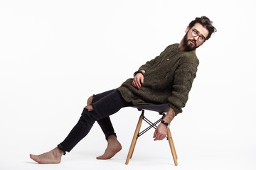 Hipster man posing on chair