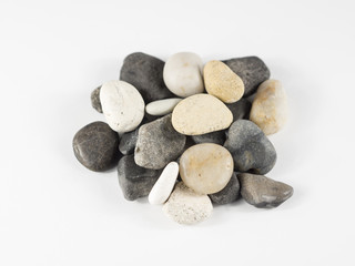 Fototapeta na wymiar River stones over white isolated background from top view