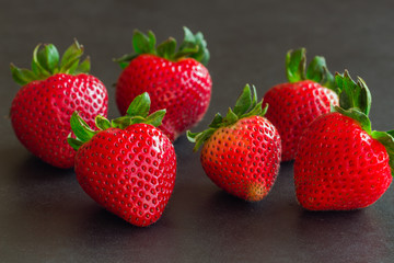 Fresh strawberries on granite background. Ripe strawberry stack on granite table. Copy space background of strawberry for your design. Extremely exposure fruit  concept background or wallpaper.