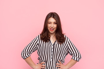 Flirty young girl posing on pink