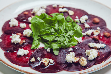 Fresh green salad with beets, goat cheese and olive oil, healthy food, organic.